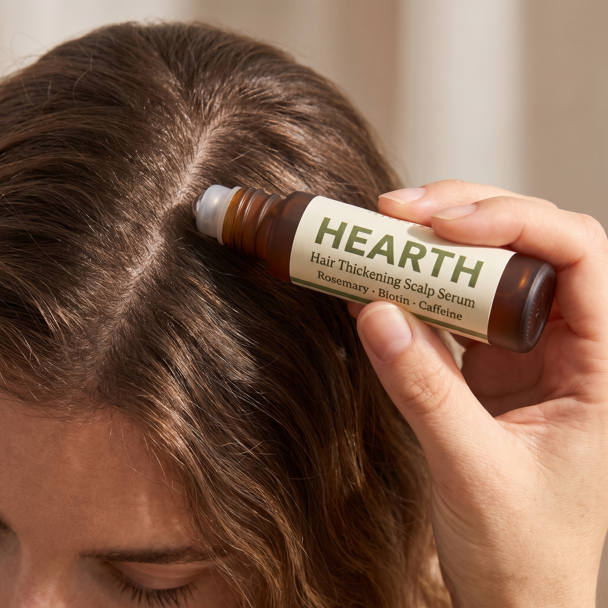 Hearth Hair Thickening Scalp Serum rolled along the part line